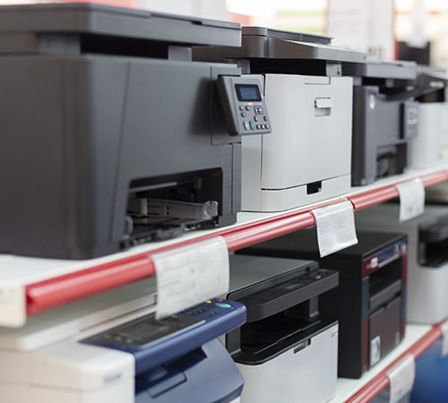 two shelves of printers and scanners